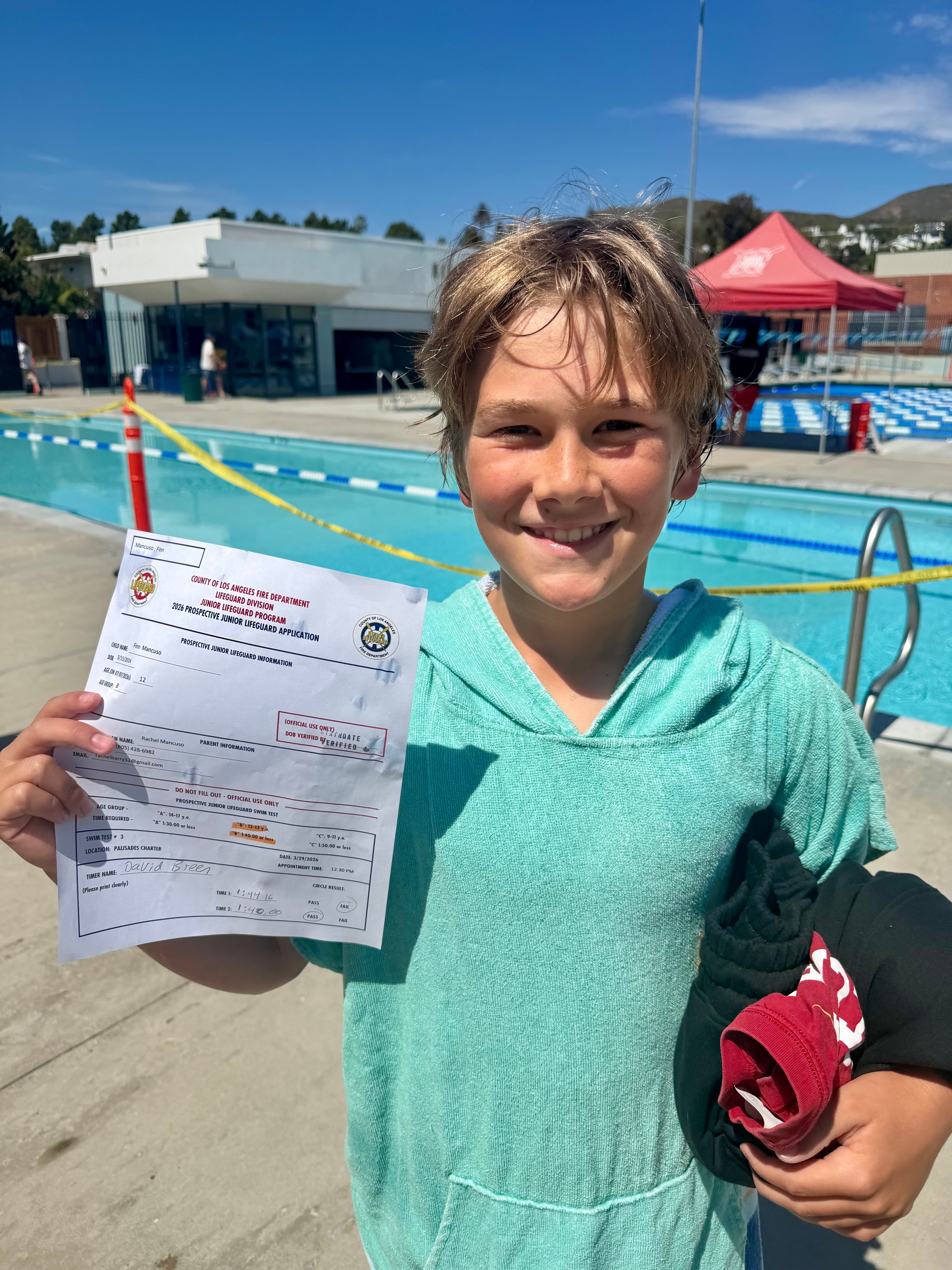 Junior Lifeguard candidate holding his prospective lifeguard application