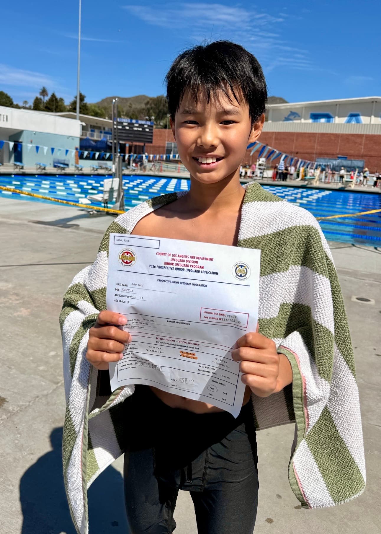Junior Lifeguard candidate showing off his completed application